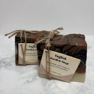 Two bars of pink, white and black soap in a swirl pattern