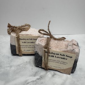 Two bars of black and pink coloured salt soap.