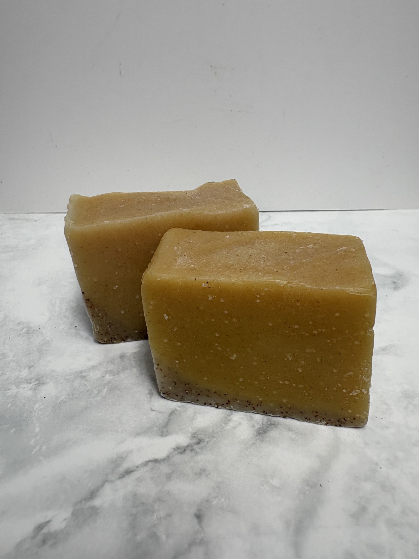 Two bars of orange coloured soap