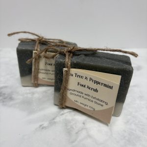 Two bars of dark green soap with a white layer along the bottom