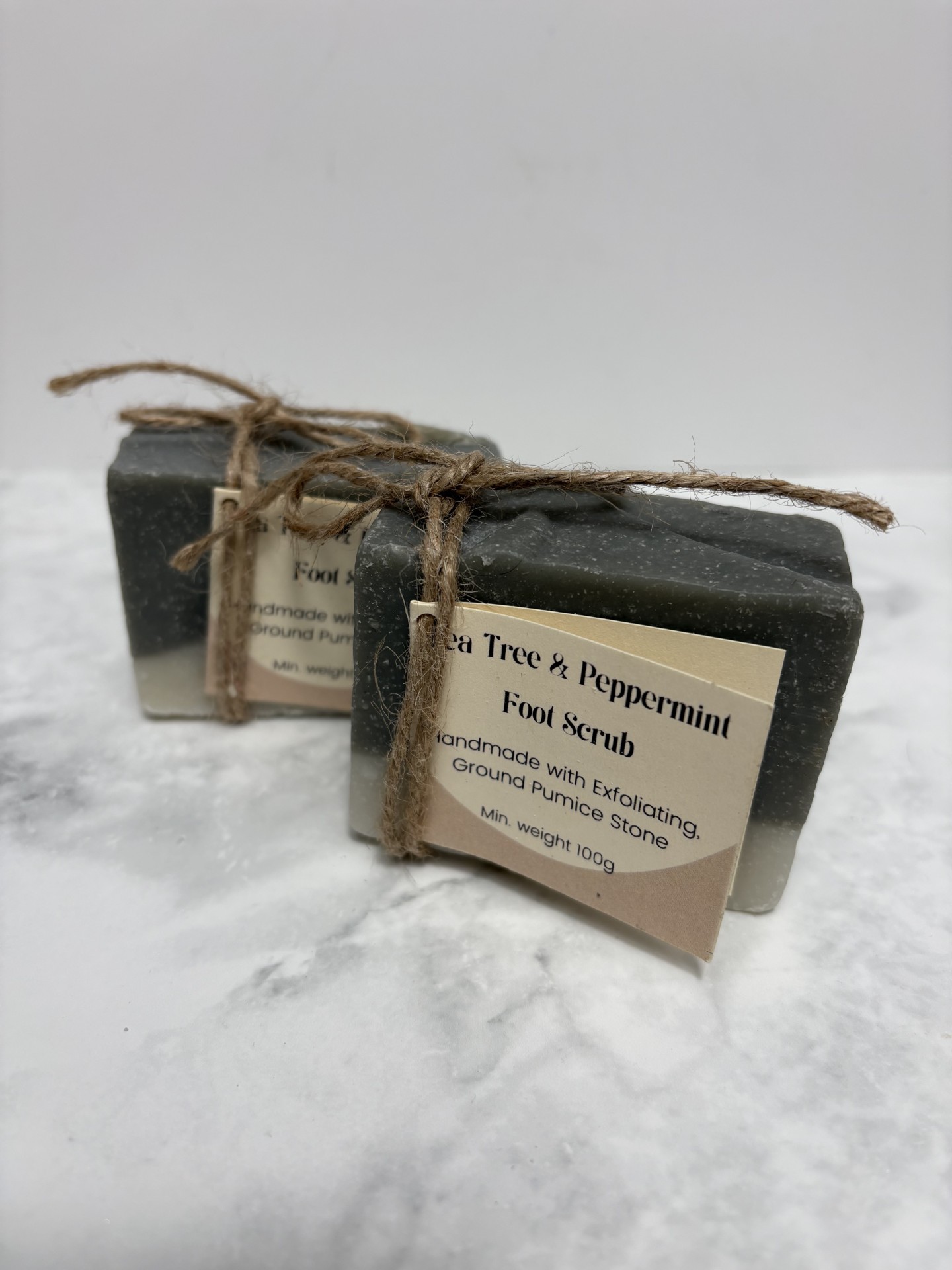 Two bars of dark green soap with a white layer along the bottom