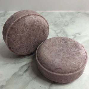 Two round, purple shampoo bars