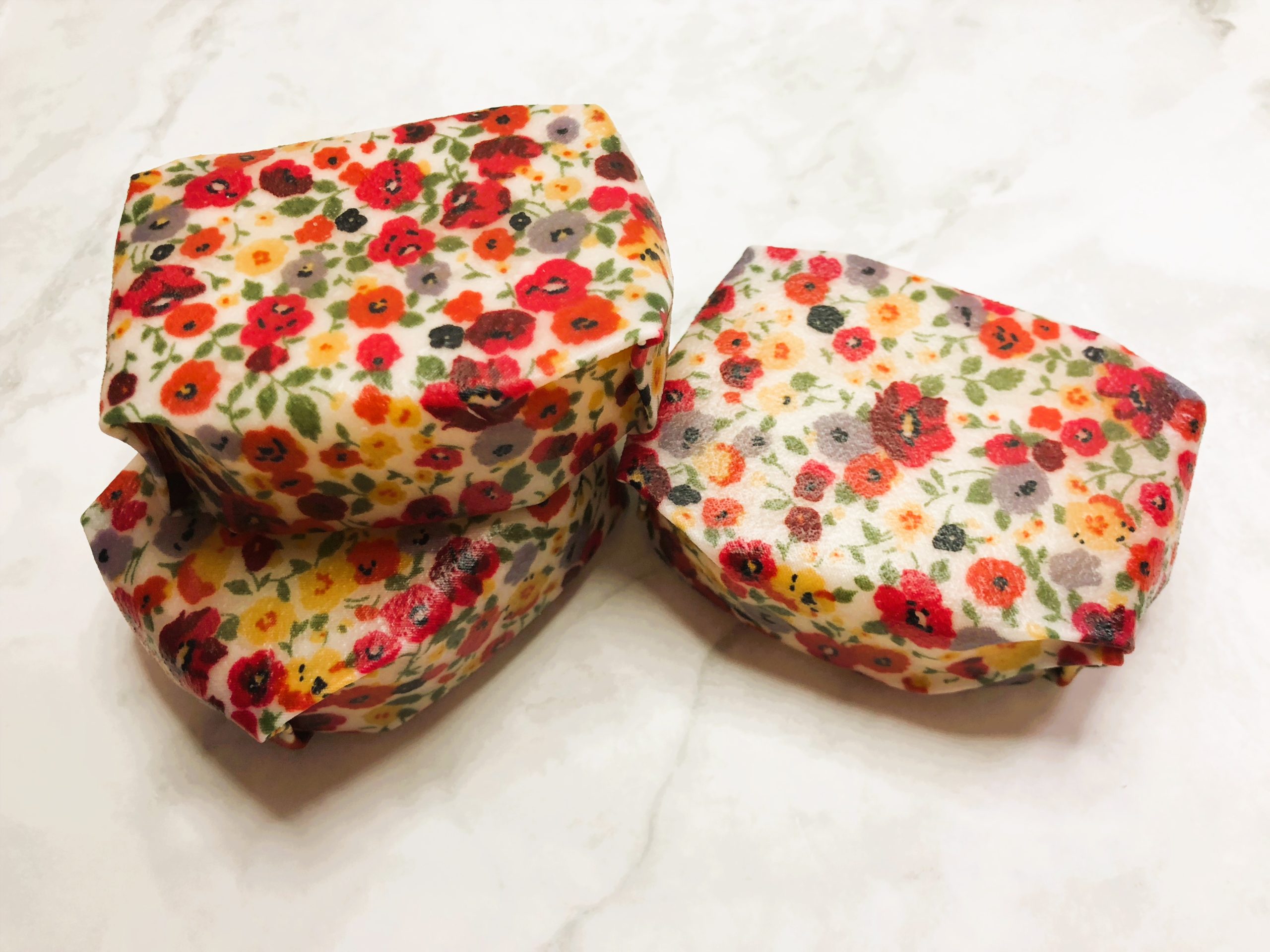 Three conditioner bars wrapped in red floral beeswax wrap